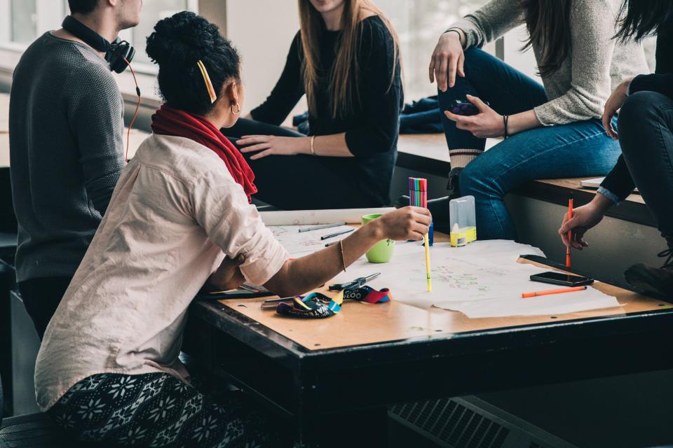 Diverse group of students collaborating around a table