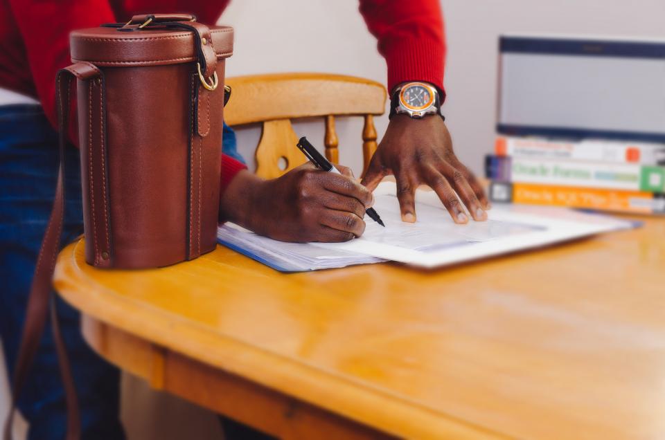 Educator working at a desk with books and notes